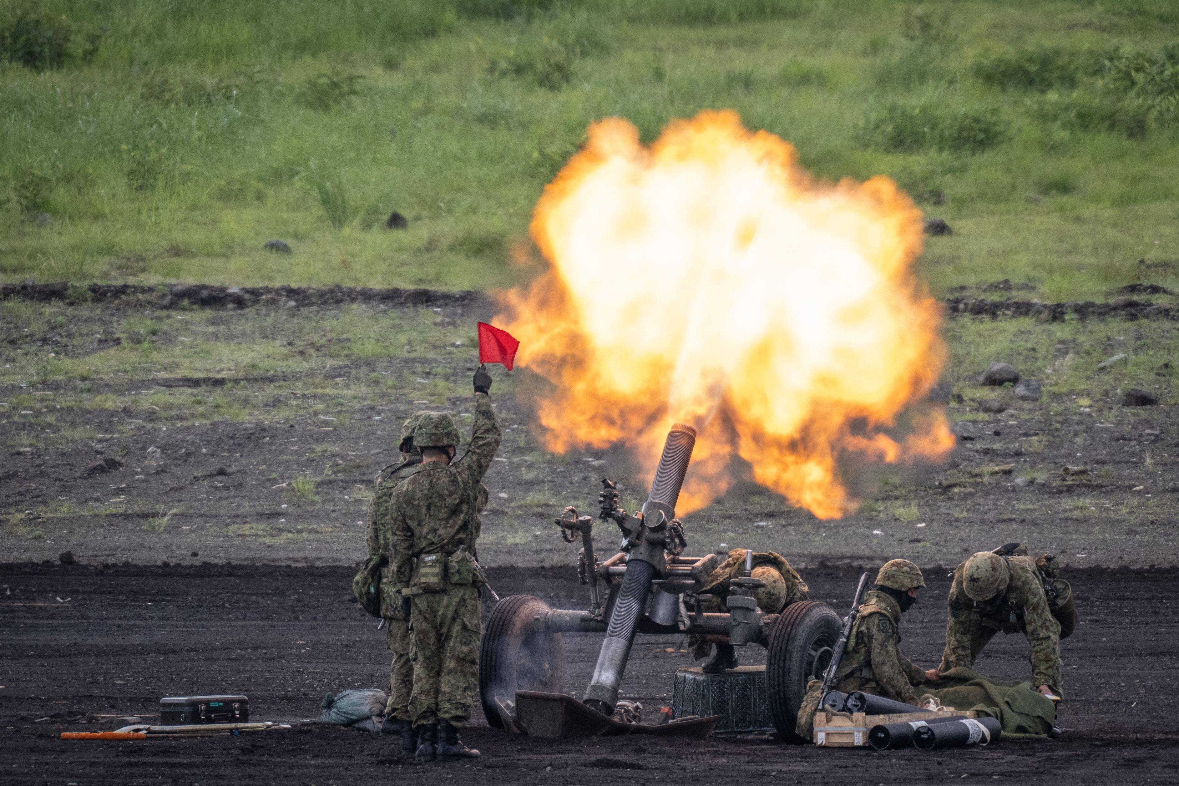 Japanese soldiers operate a howitzer during a live-fire exercise in May. Photo: AFP